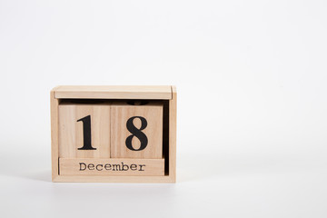 Wooden calendar December 18 on a white background