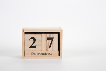 Wooden calendar December 27 on a white background