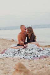 a couple in love a man and a girl meet the dawn in bed on the beach