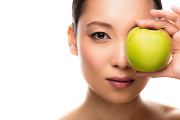 Obraz na płótnie Canvas beautiful asian girl holding green apple, isolated on white
