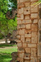 Stone decorations of a Mayan temple, depicting men with proboscis, in the archaeological area of Chichen Itza, in the Yucatan peninsula