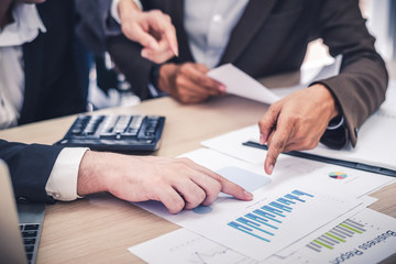 manager discussing work with his colleagues at meeting with financial paper report, business teamwork and partnership concept.