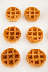 round little Viennese waffles on a white background top in perspective. Sweet background