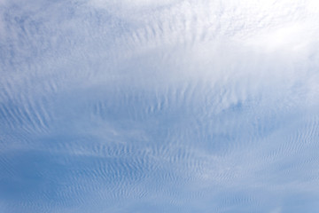 Fototapeta na wymiar Beautiful white clouds against blue sunny summer sky.