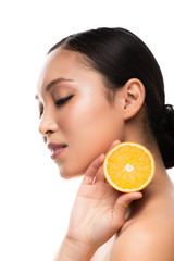 beautiful asian girl holding orange, isolated on white