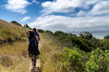 Fototapeta na wymiar Hikers on trail to Mt. Livermore on Angel Island in San Francisco Bay