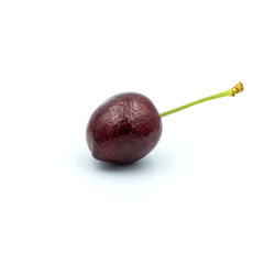 Reddish-purple cherries that are isolated on the white background