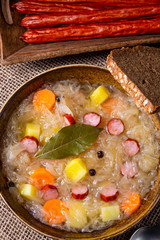 rustic sauerkraut soup with bacon and sausage