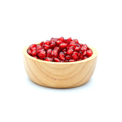 Pomegranate In a wooden cup isolated on the white background.