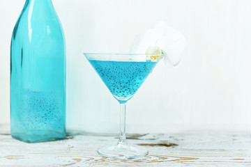 Refreshing healthy drink with chia seeds and white orchid flower. The atmosphere of summer and relaxation. Proper nutrition.