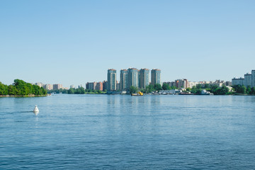 Obraz premium View of the city from the other side of the river. Beautiful landscape on the river during the daytime.