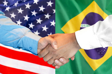 Business handshake on the background of two flags. Men handshake on the background of the Brazil...