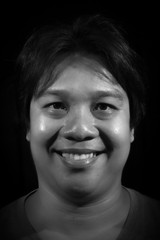 Portrait of a men smiling with in studio black background