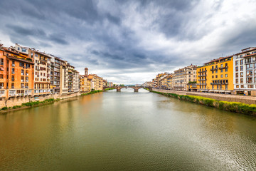 Fototapeta na wymiar View of the Arno river from the famous bridge The Ponte Vecchio in Florence, Italy.