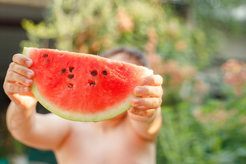  Summer healthy diet. cheerful child eating juicy watermelon. Healthy eating seasonal berries and...