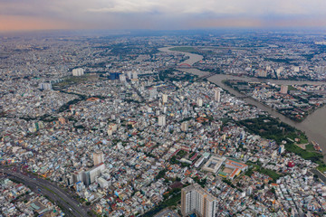 Top View of Building in a City - Aerial view Skyscrapers flying by drone of Ho Chi Mi City with development buildings, transportation, energy power infrastructure.