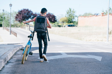 Portrait of a boy on a bicycle in park outdoors