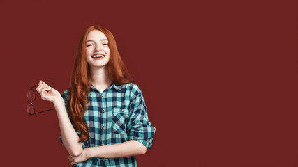 A smile is the best way to get away with trouble. Redhead girl smiling at the camera