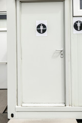 Toilets door on a container with the symbol of the male white