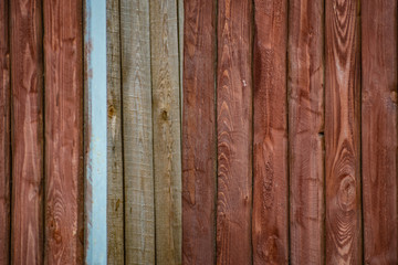 Simple background of old mahogany. Wooden fence boards and fences, with peeling paint.