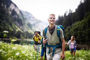 Group of happy young people friends hiking together outdoor