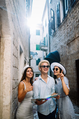 Happy group of tourists traveling and sightseeing together