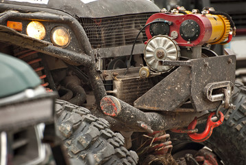 Dirty truck parts close up. Elements of the engine and suspension. Winch and rope on an SUV.