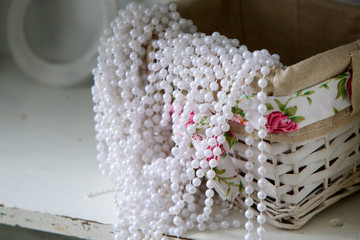 Still life of wicker basket and beads.