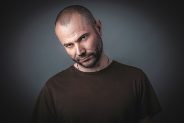 Portrait of man with confident and threatening look.