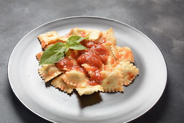 Ravioli with tomato sauce and basil, italian cuisine