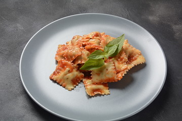 Ravioli with tomato sauce and basil, italian cuisine