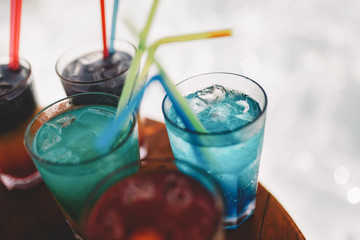Exotic summer drinks cocktails served. Blur beach as background