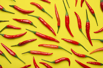 Red hot chilli pepper on yellow background