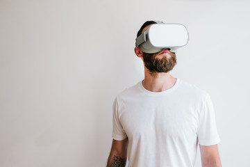 Man hipster with beard using virtual reality glasses