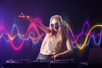 Female DJ playing music in club