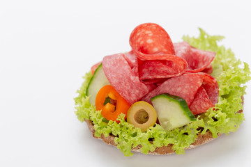 Sandwich with salami sausage on white background.