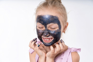 little european girl in a cosmetic mask for the face. Close-up.