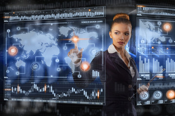 Young business lady works with virtual graphic interface in futuristic office