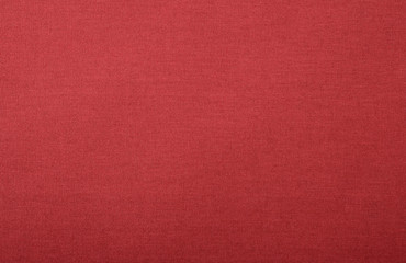 Texture of bright red fabric with visible threads