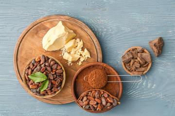 Different cocoa products on wooden background