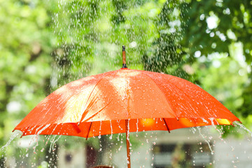 Bright umbrella outdoors on rainy day