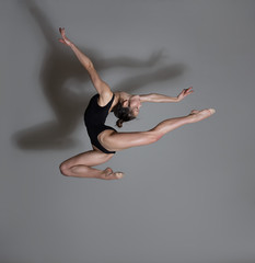 Flexible gymnast. Girl makes an expressive jump. 
