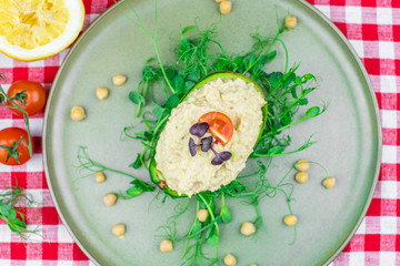 Avocado boats stuffed with hummus
