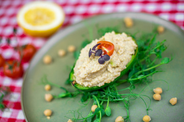 Avocado boats stuffed with hummus