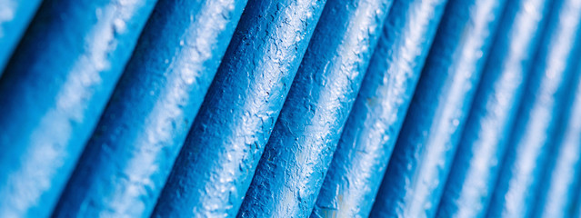 Many old blue pipes. Pipeline used in different industry ways: gas, water or vapor supply. Close up