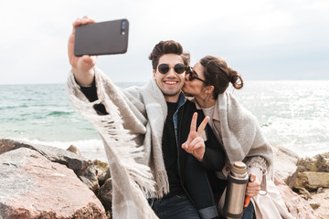 Happy young couple wearing autumn coats