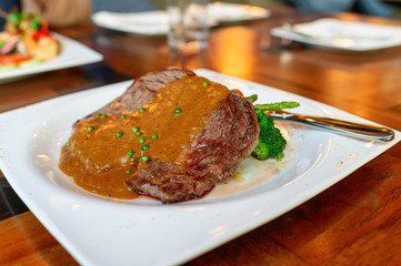 Beef steak rib eye australia grilled with ripeness medium rare with pepper sauce