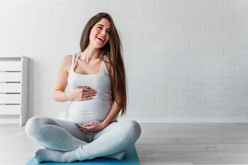 Portrait of happy smiling beautiful pregnant woman at home. Mother-to-be