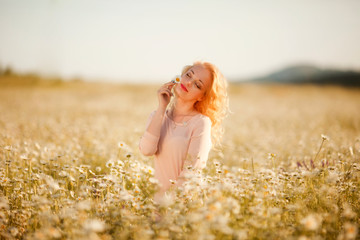 beautiful girl with white hair enjoys a field of daisies