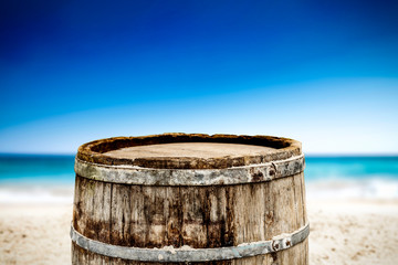 Naklejka premium Wooden barrel on beach and free space for your decoration. 